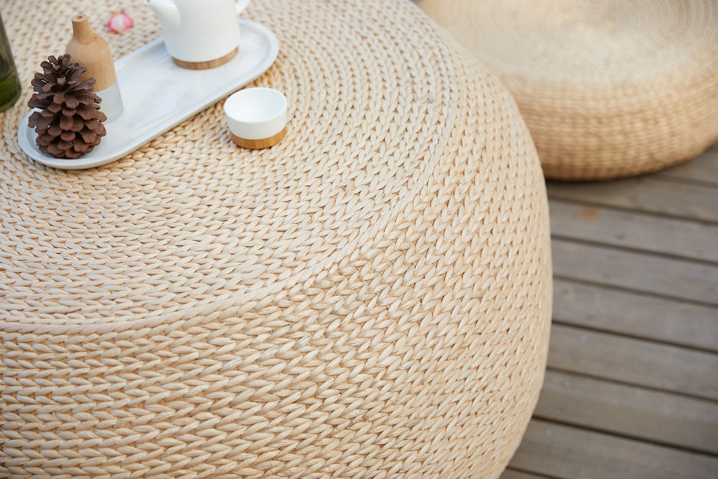 Round wood coffee table covered with straw